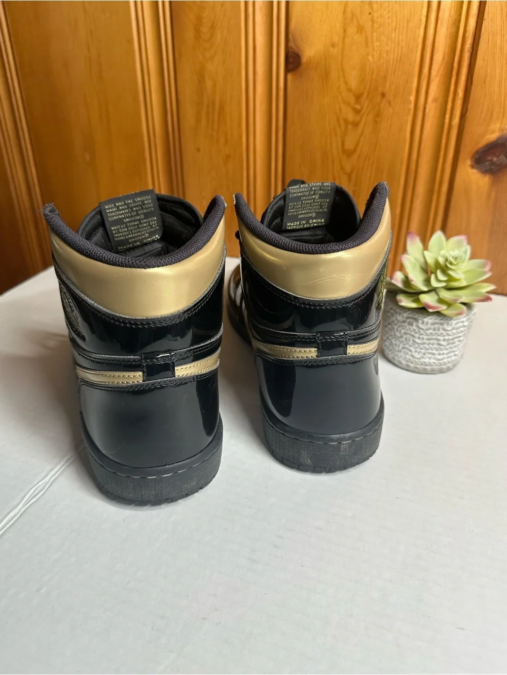 Nike Air High-Top Sneakers in Black with Gold Logo
